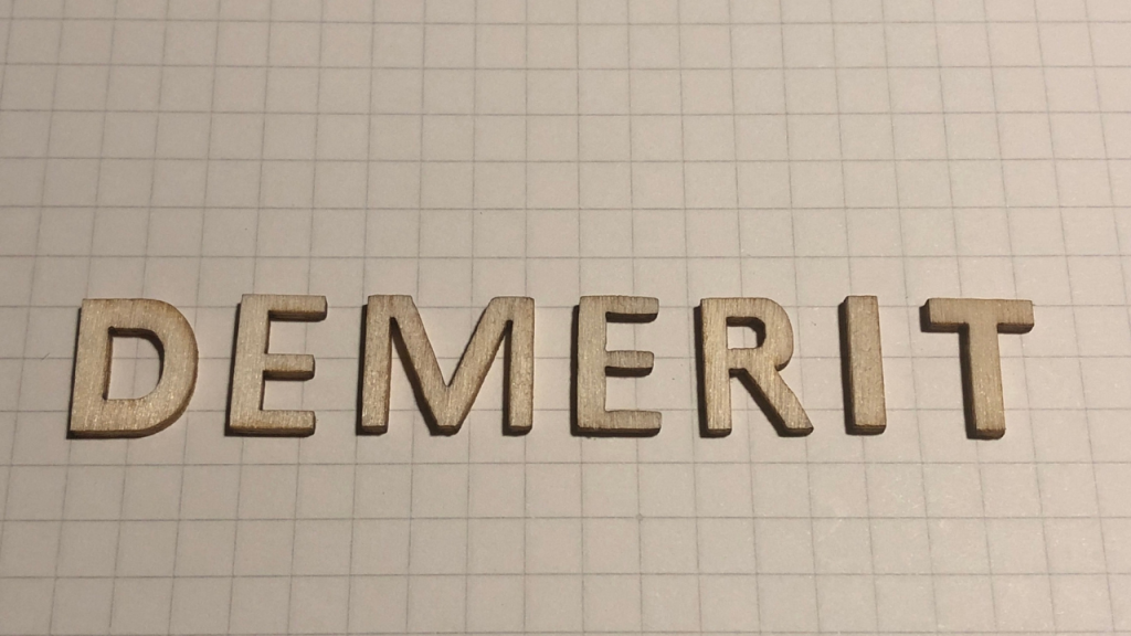 方眼紙の上に「DEMERIT」と書いてある画像